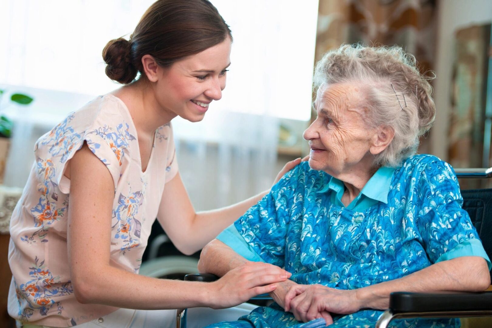 Young Woman Giving an Elderly Woman